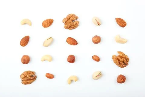 Set of different nuts on a light background. Stock Photos