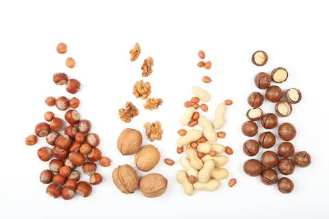 Set of different nuts on a light background. Stock Photos