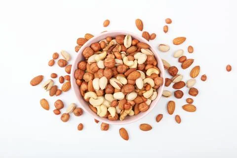 Set of different nuts on a light background. Stock Photos