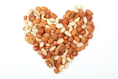 Set of different nuts on a light background. Stock Photos