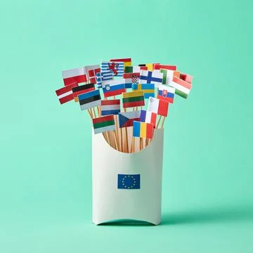 Set of different paper flags in cardboard box decorated with EU sign on gre.. Stock Photos