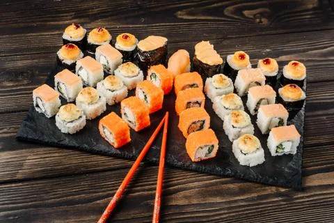 Set of different rolls and sushi on a dish with chopsticks. Stock Photos