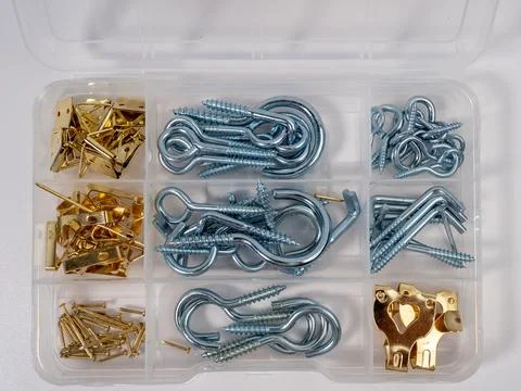 A set of different screws with a hook in a box on a white background. Stock Photos