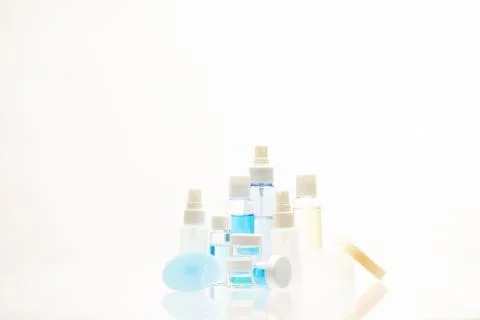 Set of different sized bottles and jars for cosmetic products on white backgound Stock Photos