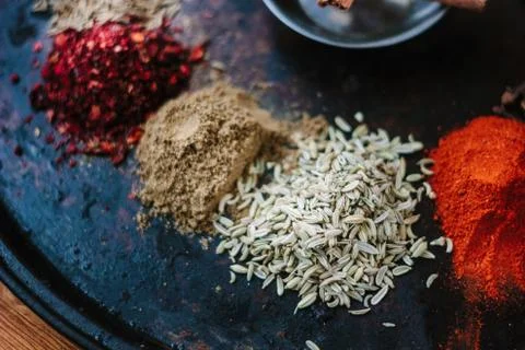 Set of different spices over black metal plate. Stock Photos
