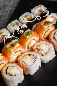Set of different sushi rolls on a dark background. Sauce and chopsticks. Top Stock Photos