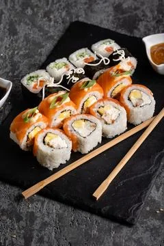 Set of different sushi rolls on a dark background. Sauce and chopsticks. Top Stock Photos