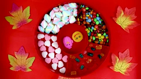 Set of different tasty candies in a red candy box on red background. Stock Footage 249977520