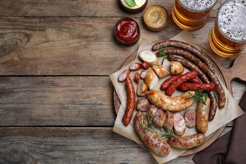 Set of different tasty snacks and beer on wooden table, flat lay. Space for t Stock Photos