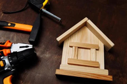 Set of different tools for repair and wooden house close-up. Fixing concept Stock Photos