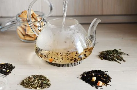 A set of different types of green, black and herbal tea, with hot brewed tea  Stock Photos