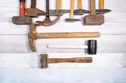 Set of different types of old hammers on a wooden background. top view. Stock Photos