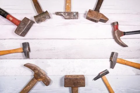 Set of different types of old hammers put in circles on a wooden background.  Stock Photos