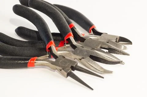 Set of different types of pliers and side cutters isolated on black backgroun Stock Photos