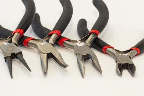 Set of different types of pliers and side cutters isolated on black backgroun Stock Photos