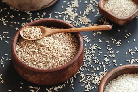 Set of different types of rice and cereals in wooden bowls and Stock Photos