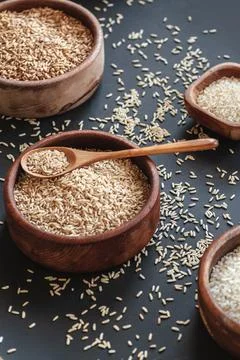 Set of different types of rice and cereals in wooden bowls and Stock Photos