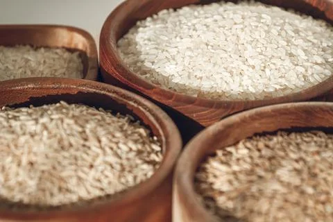 Set of different types of rice and cereals in wooden bowls Stock Photos