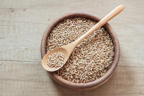 Set of different types of rice and cereals in wooden bowls Stock Photos