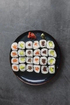 Set of different types of sushi rolls with salmon, tuna and avocado on a ru.. Stock Photos