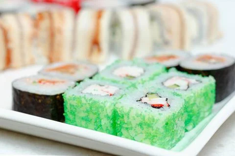 Set of different types of sushi on a white plate Stock Photos
