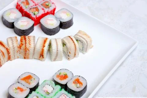 Set of different types of sushi on a white plate Stock Photos