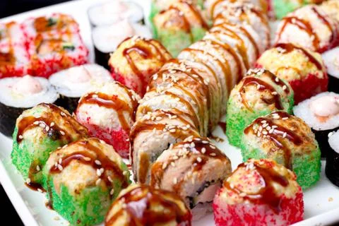 Set of different types of sushi on a white plate Photos