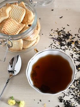 A set of different types tea next to the kettle filled with hot brewed tea on Stock Photos