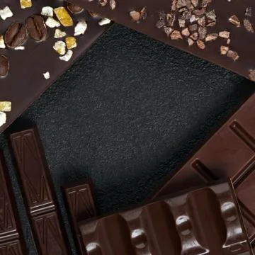 Set of different varieties of chocolate on dark stone background. Stock Photos