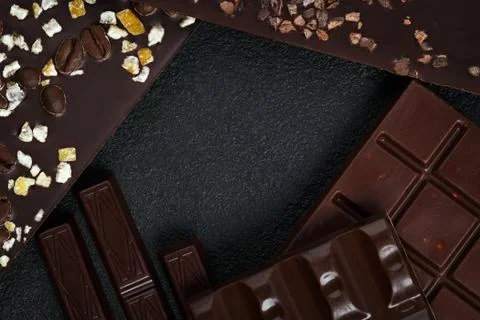 Set of different varieties of chocolate on dark stone background. Stock Photos