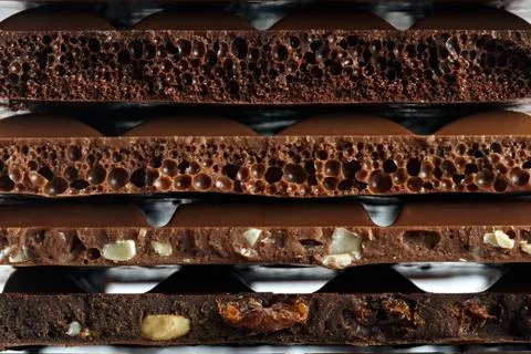 Set of different varieties of chocolate with nuts, raisins and fruit. Stock Photos