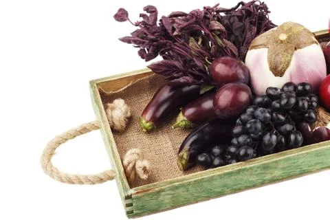 Set of different violet vegetables and fruits in the wooden tray Stock-Fotos