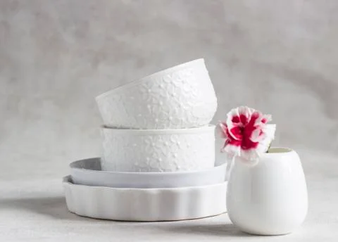 Set of different white ceramic dishes. Elegant white tableware. Stock Photos