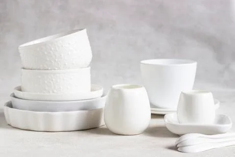 Set of different white ceramic dishes. Elegant white tableware. Stock Photos