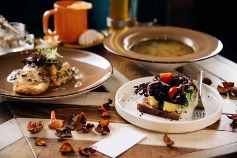 Set dinner of three courses. Chef's specialty presented in restaurant on serv Stock Photos