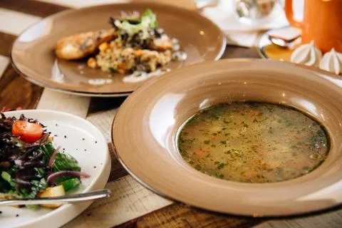 Set dinner of three courses. Chef's specialty presented in restaurant on serv Stock Photos