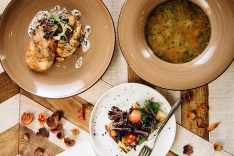 Set dinner of three courses. Chef's specialty presented in restaurant on serv Stock Photos