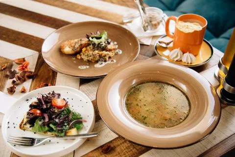 Set dinner of three courses. Chef's specialty presented in restaurant on serv Stock Photos