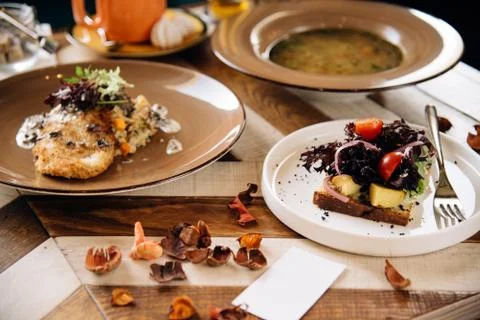Set dinner of three courses. Chef's specialty presented in restaurant on serv Stock Photos