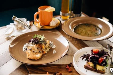 Set dinner of three courses. Chef's specialty presented in restaurant on serv Stock Photos