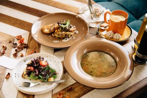 Set dinner of three courses. Chef's specialty presented in restaurant on serv Stock Photos