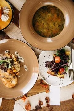 Set dinner of three courses. Chef's specialty presented in restaurant on serv Stock Photos