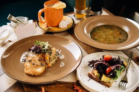 Set dinner of three courses. Chef's specialty presented in restaurant on serv Stock Photos