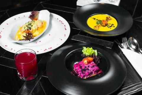 Set dinner of three courses. Chef's specialty presented in restaurant on serv Stock Photos