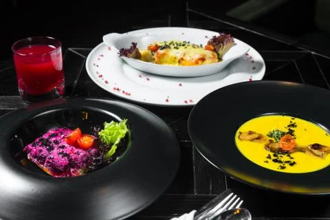 Set dinner of three courses. Chef's specialty presented in restaurant on serv Stock Photos