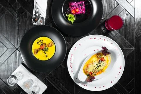 Set dinner of three courses. Chef's specialty presented in restaurant on serv Stock Photos