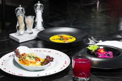 Set dinner of three courses. Chef's specialty presented in restaurant on serv Stock Photos
