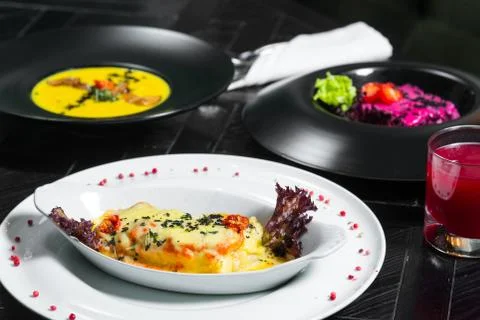 Set dinner of three courses. Chef's specialty presented in restaurant on serv Stock Photos