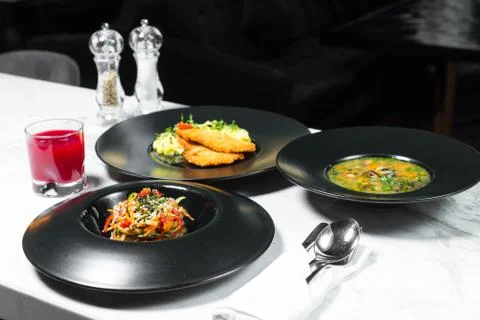 Set dinner of three courses. Chef's specialty presented in restaurant on serv Stock Photos