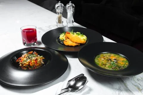 Set dinner of three courses. Chef's specialty presented in restaurant on serv Stock Photos